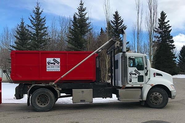 red bin on roll-off truck